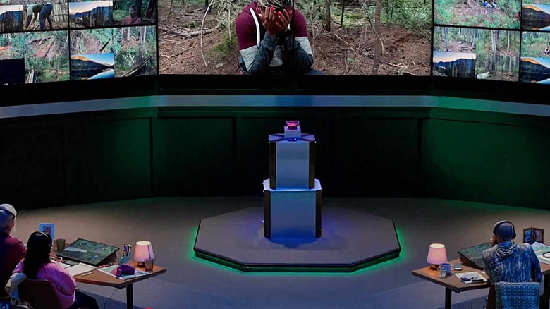 Families watch a woman in the forest on the screen