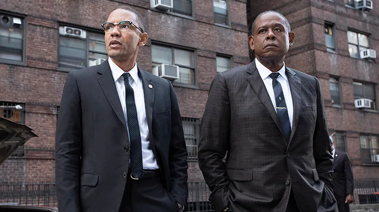 Nigél Thatch and Forest Whitaker as Malcolm X and Bumpy Johnson standing in a neighborhood on Godfather of Harlem