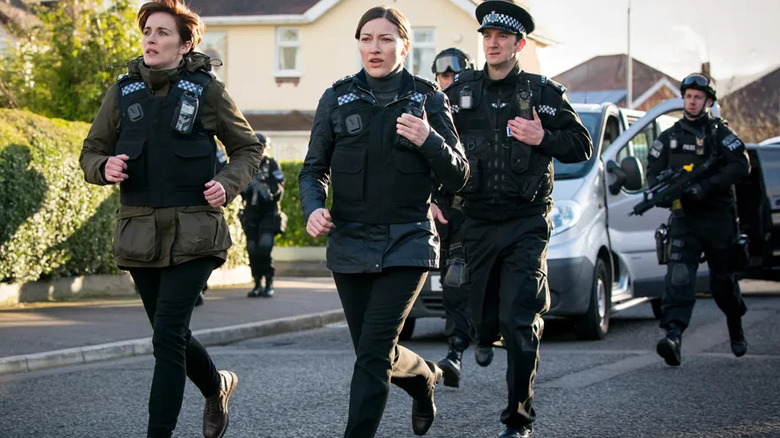 British police officer run away from a car on Line of Duty