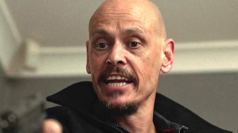 Scott Ryan as Ray, aiming a gun in Mr. Inbetween