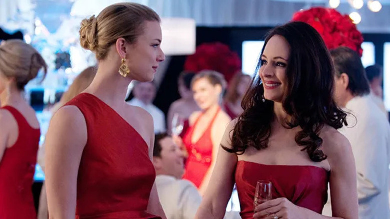 Emily VanCamp and Madeleine Stowe as Emily and Victoria wearing red dresses on Revenge