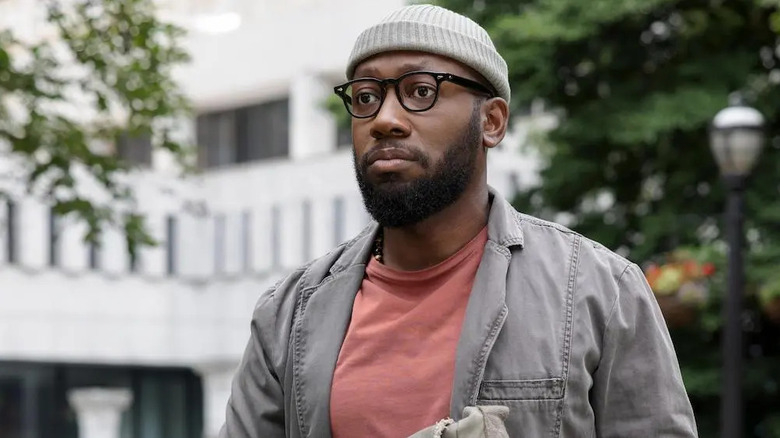 Lamorne Morris as Keef Knight frowning in the street on woke