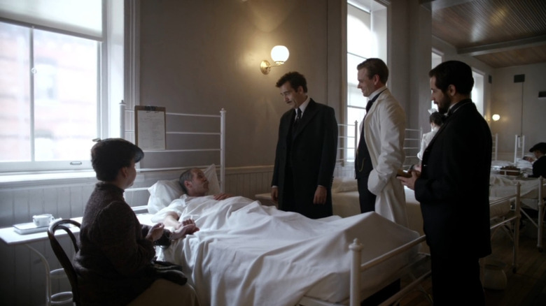 Thackery (Clive Owens) and colleagues at bedside of patient in The Knick