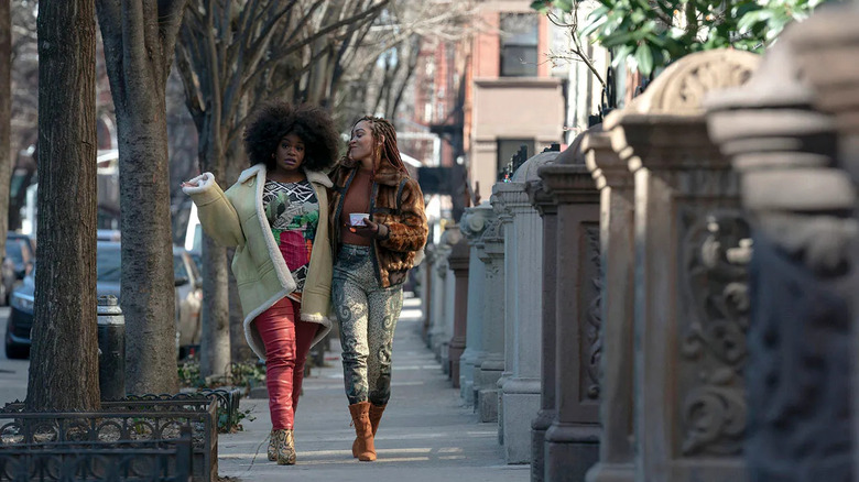 Angie Wilson (Soniqua Shandai) walks down the sidewalk with Camille Parks (Meagan Good) in Harlem