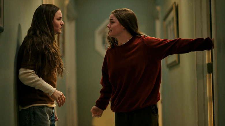 Tegan (Railey Gilliland) and Sara Quin (Seazynn Gilliland) argue in a hallway in High School