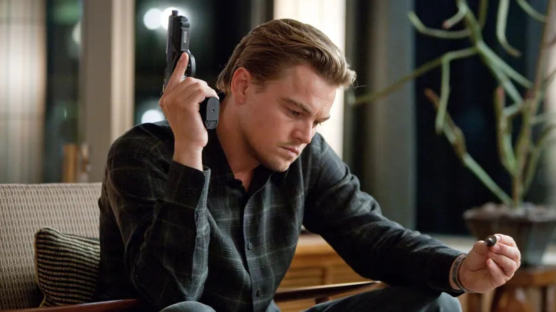 Leonardo DiCaprio as Dom Cobb, staring at a top in Inception.