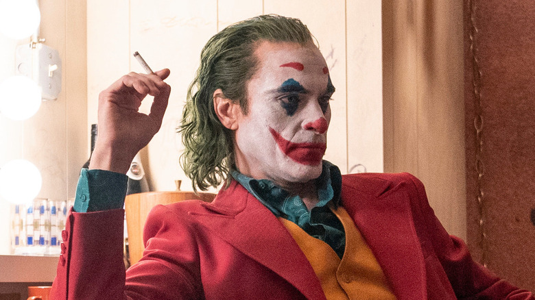 Joaquin Phoenix as Arthur Fleck, smoking backstage in Joker.