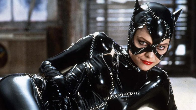 Michelle Pfeiffer as Catwoman lies in a bed in Batman Returns