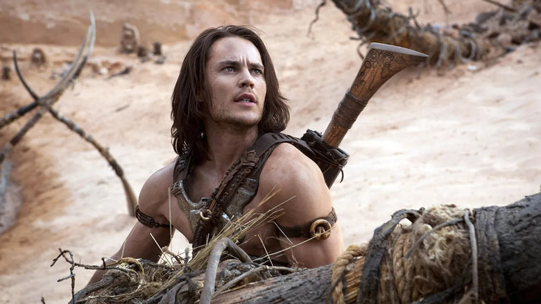 Taylor Kitsch as John Carter sits in the desert in John Carter