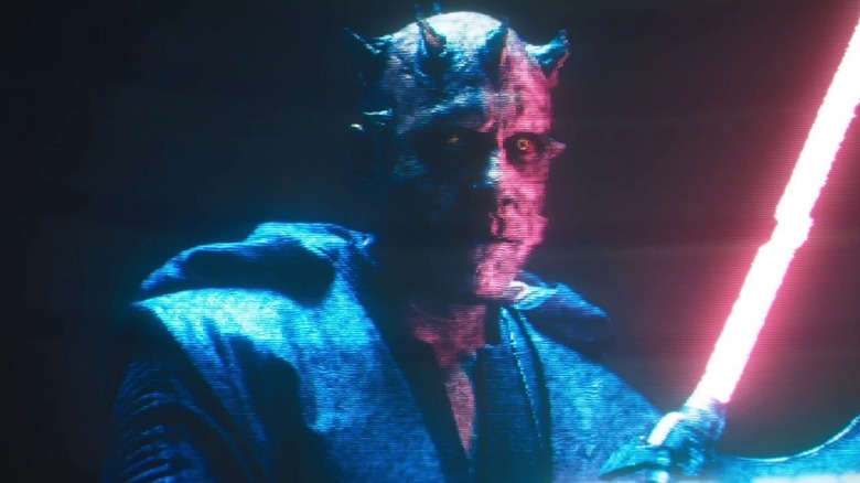 Ray Park as Darth Maul holds a red lightsaber in Solo: A Star Wars Story
