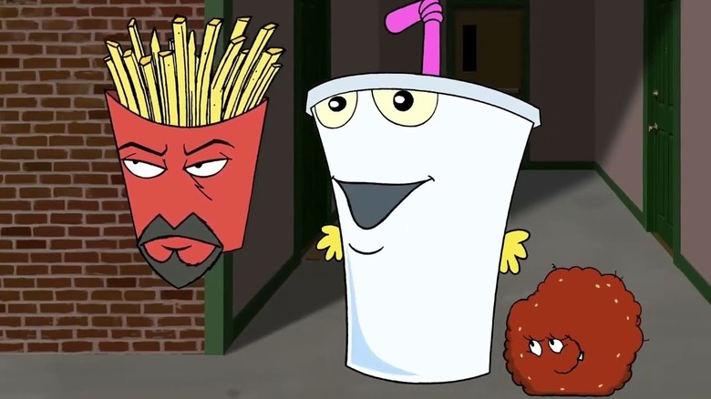 Animated red basket of fries with eyes and facial hair milkshake with eyes and mouths and hands, and a small meatball with mouth and eyes in Aqua Teen Hunger Force Colon Movie Film for Theaters