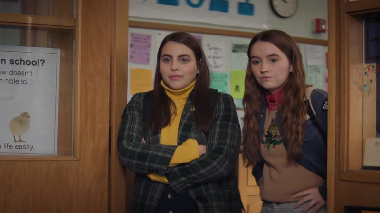 Amy (Kaitlyn Dever) and Molly (Beanie Feldstein) stand in principal's doorway in Booksmart