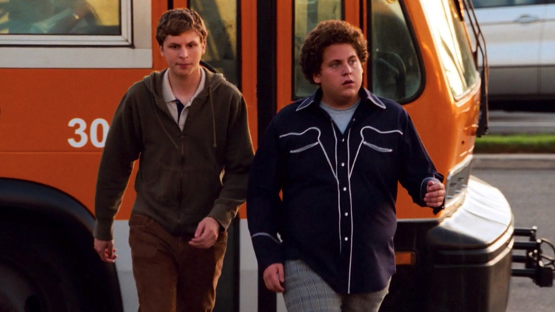 Evan (Michael Cera) and Seth (Jonah Hill) do tough walk off school bus in Superbad