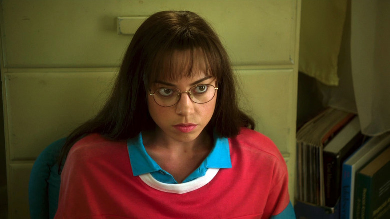 Brandy (Aubrey Plaza) looks worried, sitting against a dresser in  The To Do List