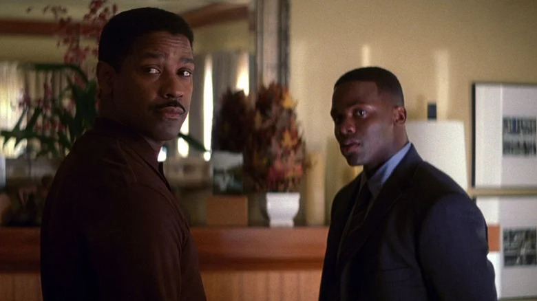 Denzel Washington with mustache as Davenport turning around to look at something next to Derek Luke as Antwone in Antwone Fisher