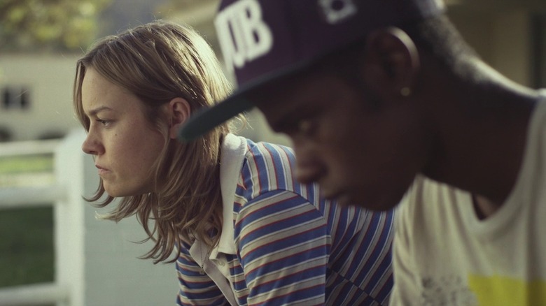 Brie Larson as Grace in striped blue shirt sitting next to LaKeith Stanfield as Marcus in black baseball cap in Short Term 12