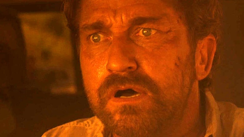 Greenland Gerard Butler looks shocked orange light