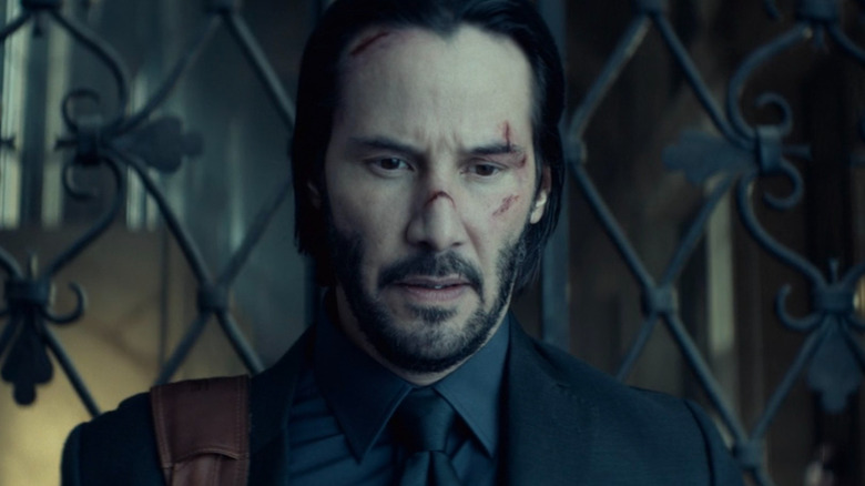 John Wick (Keanu Reeves) exiting the Continental in John Wick