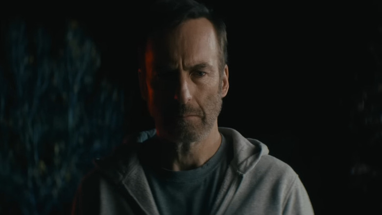 Hutch Mansell (Bob Odenkirk) illuminated by police lights in Nobody
