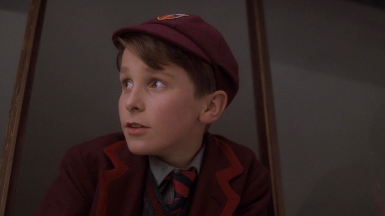 Christian Bale as Jamie wearing a hat and looking to the side in Empire of the Sun