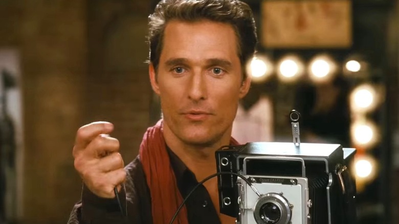 Matthew McConaughey as Connor Mead holding a camera in Ghosts of Girlfriends Past