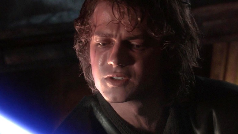 Hayden Christensen as Anakin Skywalker holding a lightsaber and looking down in Star Wars: Revenge of the Sith