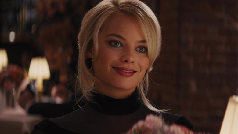 Margot Robbie as Naomi Lapaglia smiling in The Wolf of Wall Street