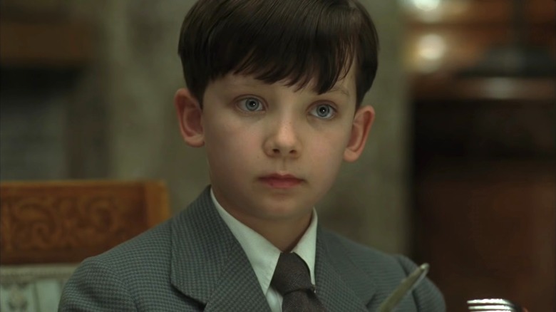 Asa Butterfield as Bruno staring ahead in The Boy in the Striped Pajamas
