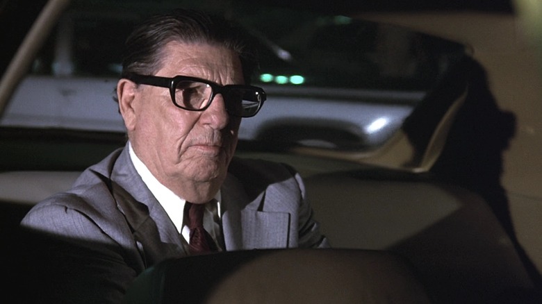 Howard Jarvis as a passenger calmly waits in a taxi cab in Airplane!