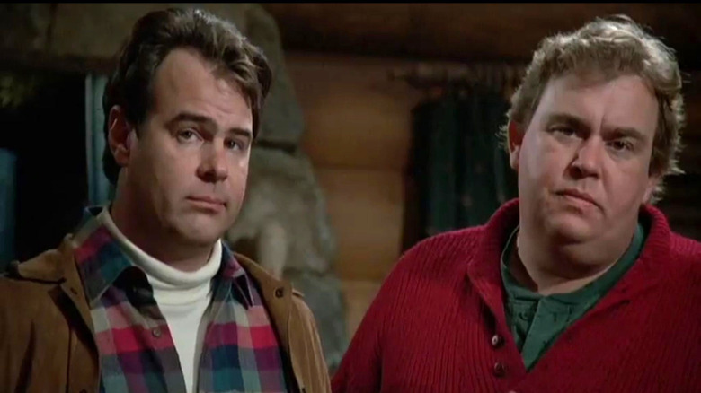 Dan Aykroyd as Roman Craig frowns next to John Candy as Chet Ripley in The Great Outdoors