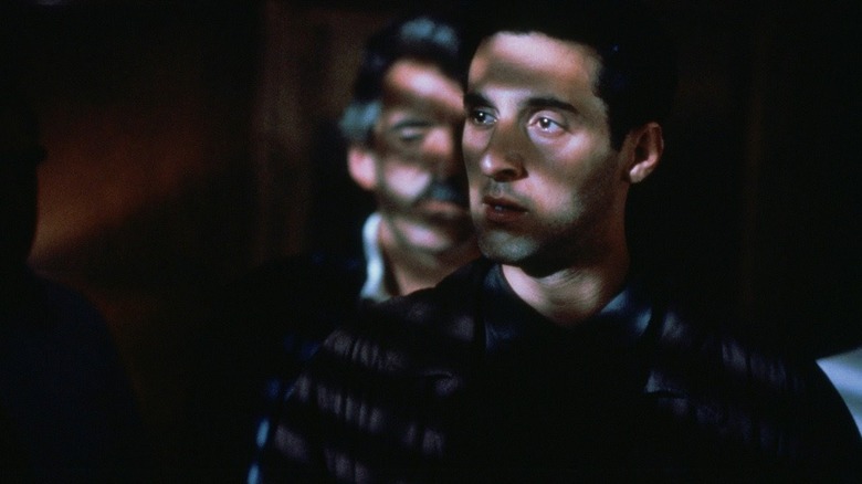 Bankie Como (Dennis Farina) whispers to Mike Battaglia (John Turturro) in Men of Respect