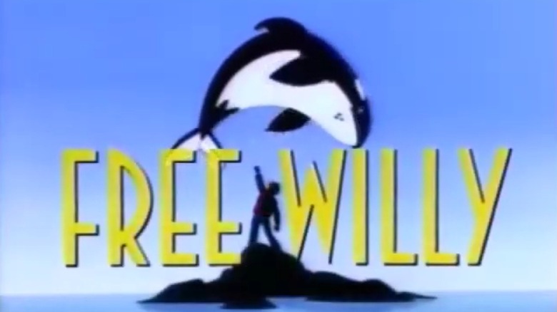 A whale jumping over a boy's silhouette with the yellow Free Willy logo overtop
