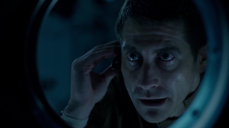 Dr. David Jordan (Jake Gyllenhaal) looking through spaceship window in Life