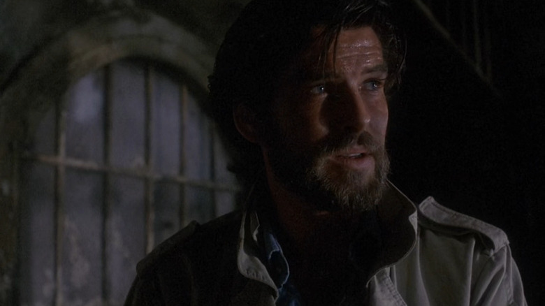 Jean-Charles Pommier (Pierce Brosnan) cloaked in shadow in Nomads