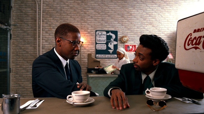 Malcolm X (Denzel Washington) talks with Shorty (Spike Lee) in Malcolm X