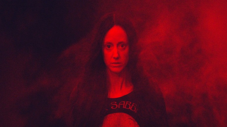 Mandy (Andrea Riseborough) stares in smoke in Mandy