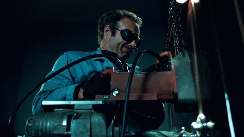 Frank (James Caan) works on cracking a safe in Thief