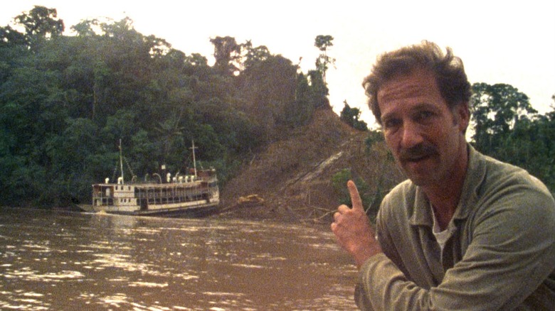 Werner Herzog pointing to his boat being hauled up a hill