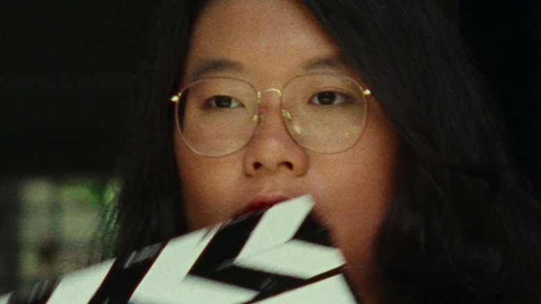 Sandi Tan behind a clapperboard