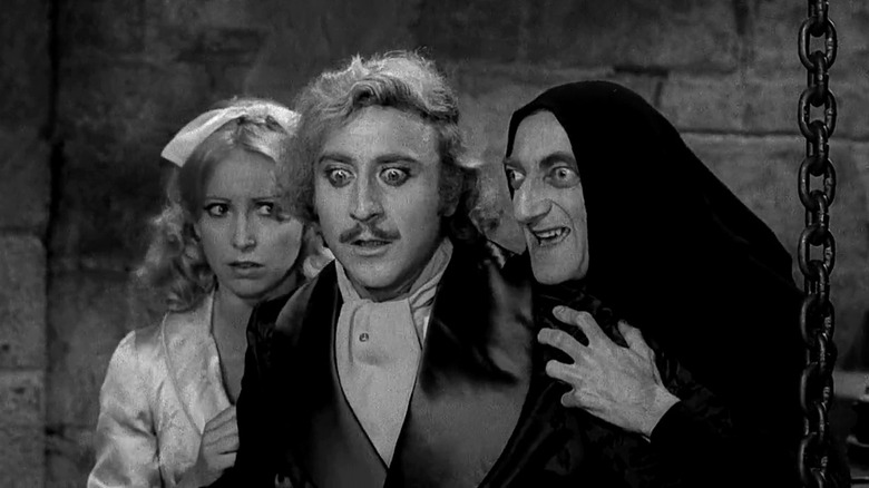 Teri Garr as Inga and Marty Feldman as Igor hold onto Gene Wilder as Frederick Frankenstein in Young Frankenstein