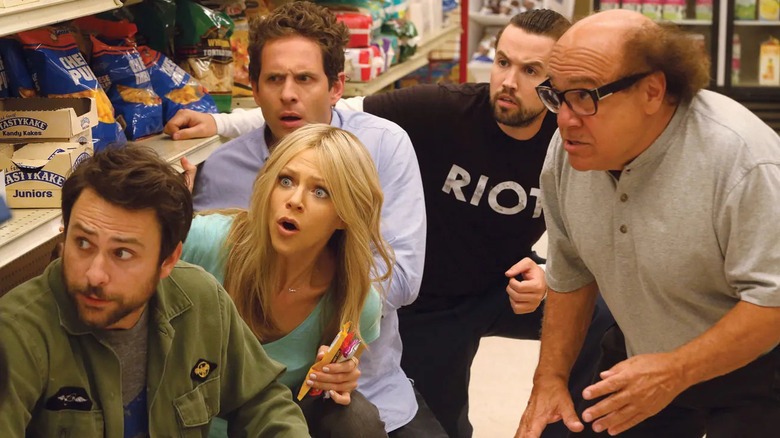 The entire gang from Its Always Sunny in Philadelphia, hiding in a grocery aisle on the show It's Always Sunny in Philadelphia