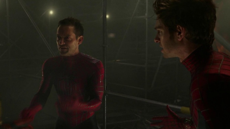 Tobey Maguire and Andrew Garfield as Peter Parker pointing at each other in their Spiderman suits in Spider-Man: No Way Home