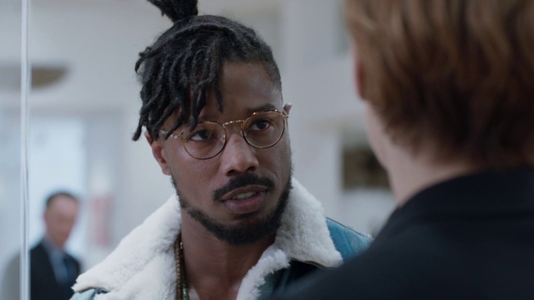 Michael B. Jordan as Killmonger in Black Panther wearing wire-rim glasses