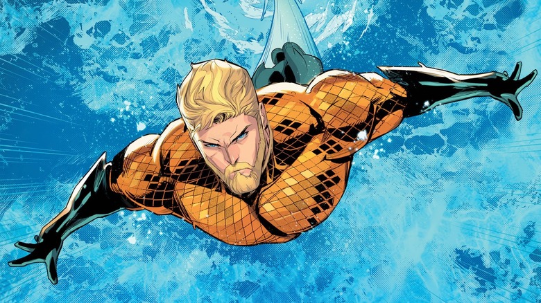 Aquaman dives through the ocean, determined, arms outstretched