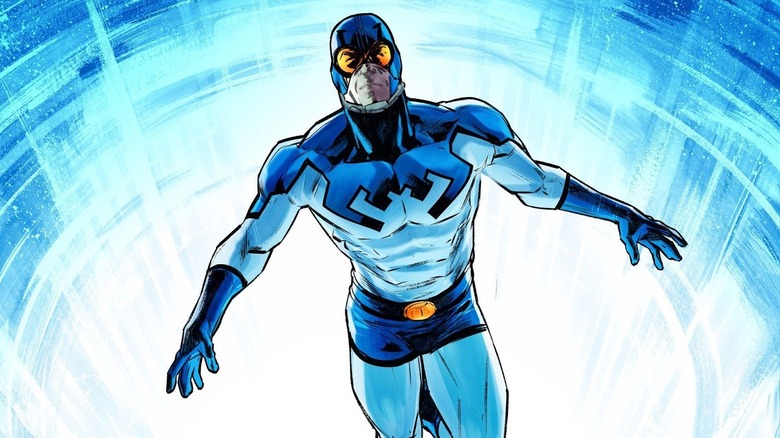 Blue Beetle (Ted Kord) emerges from a blue light