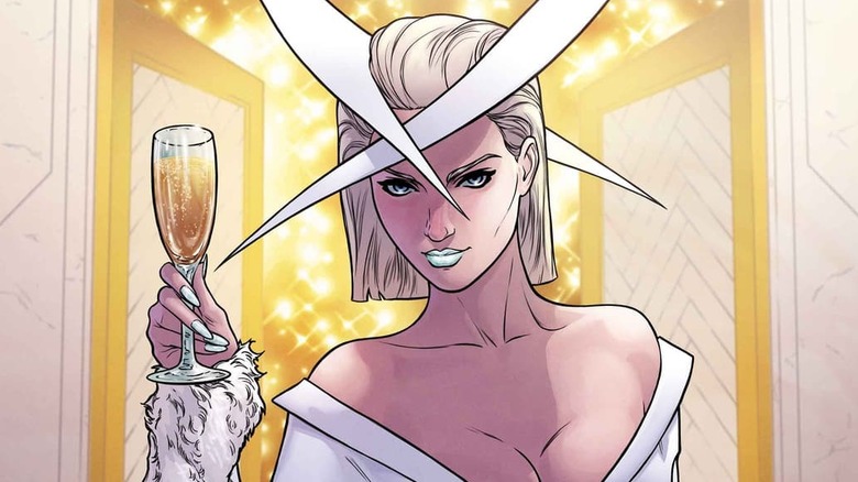 Emma Frost wearing a white dress and holding a glass of champagne