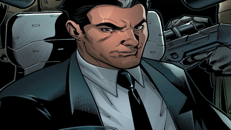 Roberto da Costa, wearing a suit and surrounded by guns