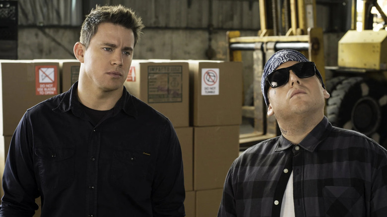 Channing Tatum as Jenko standing next to Jonah Hill as Schmidt wearing a gang member costume in 22 Jump Street