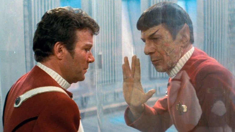 Leonard Nimoy as Spock holding a Vulcan peace sign against glass to William Shatner as Kirk in Star Trek II