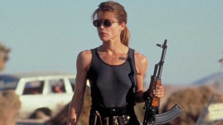 Linda Hamilton as Sarah Connor holding an assault rifle outside in Terminator 2
